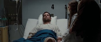 Movie still from “The Burning Plain” (2008), directed by Guillermo Arriaga – A man laying in a hospital bed next to a woman; Medium shot, High angle
