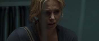 Movie still from “The Burning Plain” (2008), directed by Guillermo Arriaga – A woman with blonde curly hair is looking at the camera; Close Up shot, Over the shoulder angle