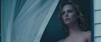 Movie still from “The Burning Plain” (2008), directed by Guillermo Arriaga – A woman standing in front of a curtain; Close Up shot, Low angle