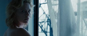 Movie still from “The Burning Plain” (2008), directed by Guillermo Arriaga – A woman standing in front of a window looking out; Close Up shot, Low angle
