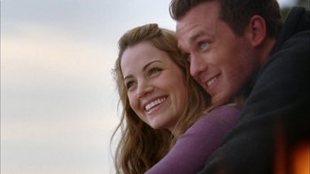 Movie still from “The Butterfly Effect 2” (2006), directed by John R. Leonetti – A man and a woman smiling for the camera; Close Up shot, Low angle