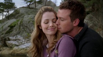 Movie still from “The Butterfly Effect 2” (2006), directed by John R. Leonetti – A man and a woman kissing in front of some rocks; Close Up shot, Over the shoulder angle