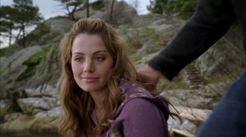 Movie still from “The Butterfly Effect 2” (2006), directed by John R. Leonetti – A woman in a purple shirt is looking at the camera; Close Up shot, Over the shoulder angle