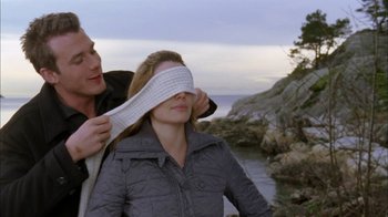 Movie still from “The Butterfly Effect 2” (2006), directed by John R. Leonetti – A man putting a blindfold on a woman's face; Close Up shot, Over the shoulder angle