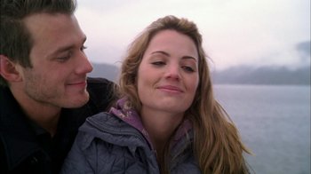 Movie still from “The Butterfly Effect 2” (2006), directed by John R. Leonetti – A man and a woman smiling for the camera; Close Up shot, Over the shoulder angle