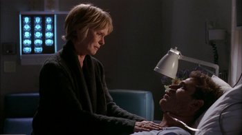 Movie still from “The Butterfly Effect 2” (2006), directed by John R. Leonetti – An older woman sitting next to an older man in a chair; Close Up shot, Over the shoulder angle