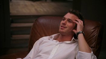 Movie still from “The Butterfly Effect 2” (2006), directed by John R. Leonetti – A man sitting in a chair with his hand on his head; Close Up shot, High angle