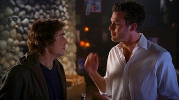 Movie still from “The Butterfly Effect 2” (2006), directed by John R. Leonetti – Two men are having a conversation in a bar; Medium shot, Over the shoulder angle