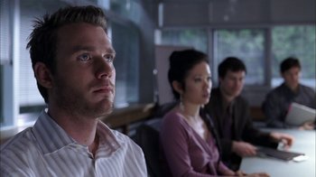 Movie still from “The Butterfly Effect 2” (2006), directed by John R. Leonetti – A man and two women sitting next to each other in a room; Close Up shot, Over the shoulder angle