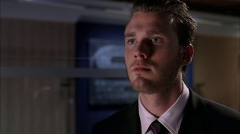 Movie still from “The Butterfly Effect 2” (2006), directed by John R. Leonetti – A person wearing a suit and tie; Close Up shot, Over the shoulder angle