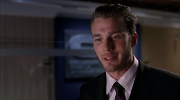 Movie still from “The Butterfly Effect 2” (2006), directed by John R. Leonetti – A man wearing a suit and tie in front of a mirror; Close Up shot, Over the shoulder angle