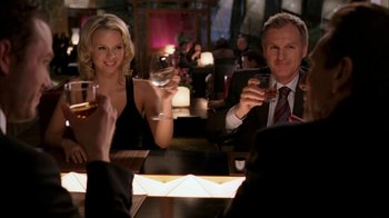 Movie still from “The Butterfly Effect 2” (2006), directed by John R. Leonetti – A man and a woman sitting at a table with drinks in front of them; Medium shot, Over the shoulder angle