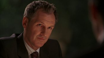 Movie still from “The Butterfly Effect 2” (2006), directed by John R. Leonetti – A person wearing a suit and tie; Close Up shot, Low angle