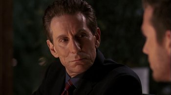 Movie still from “The Butterfly Effect 2” (2006), directed by John R. Leonetti – A person wearing a suit and tie; Close Up shot, Low angle