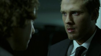Movie still from “The Butterfly Effect 2” (2006), directed by John R. Leonetti – A man wearing a suit and tie talking to another man in a suit and tie; Close Up shot, Over the shoulder angle