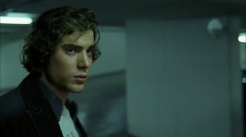 Movie still from “The Butterfly Effect 2” (2006), directed by John R. Leonetti – A young man in a suit and tie looking to his left; Close Up shot, Low angle