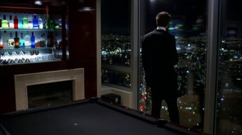 Movie still from “The Butterfly Effect 2” (2006), directed by John R. Leonetti – A man in a suit looking out a window at night; Wide shot, High angle