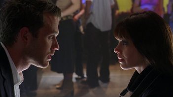 Movie still from “The Butterfly Effect 2” (2006), directed by John R. Leonetti – A man and a woman face to face in front of a group of people; Close Up shot, Over the shoulder angle