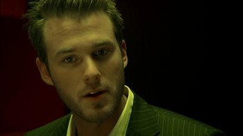 Movie still from “The Butterfly Effect 2” (2006), directed by John R. Leonetti – A person wearing a suit and tie; Close Up shot, Over the shoulder angle