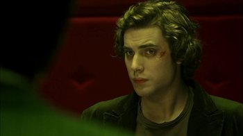 Movie still from “The Butterfly Effect 2” (2006), directed by John R. Leonetti – A young man with green eyes stares at the camera; Close Up shot, Over the shoulder angle