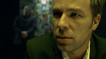 Movie still from “The Butterfly Effect 2” (2006), directed by John R. Leonetti – A person wearing a suit and tie; Close Up shot, Over the shoulder angle