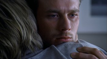 Movie still from “The Butterfly Effect 2” (2006), directed by John R. Leonetti – A person holding a blanket; Close Up shot, Over the shoulder angle