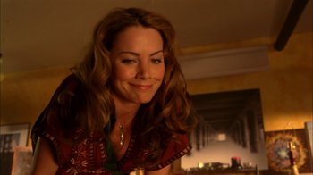Movie still from “The Butterfly Effect 2” (2006), directed by John R. Leonetti – A beautiful woman with long brown curly hair smiling; Close Up shot, Over the shoulder angle