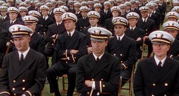 Movie still from “The Caine Mutiny” (1954), directed by Edward Dmytryk – A group of men in navy uniforms sitting in rows; Wide shot, High angle