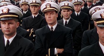 Movie still from “The Caine Mutiny” (1954), directed by Edward Dmytryk – A group of men in navy uniforms standing in a row; Medium shot, High angle