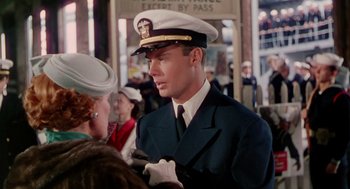 Movie still from “The Caine Mutiny” (1954), directed by Edward Dmytryk – A man in a naval uniform talking to a woman; Medium shot, Over the shoulder angle