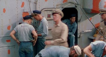 Movie still from “The Caine Mutiny” (1954), directed by Edward Dmytryk – A group of men standing next to each other on a boat; Wide shot, High angle