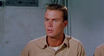Movie still from “The Caine Mutiny” (1954), directed by Edward Dmytryk – A person wearing a tan shirt; Close Up shot, Low angle