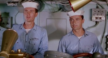 Movie still from “The Caine Mutiny” (1954), directed by Edward Dmytryk – Two men in blue shirts and white hats on a boat; Medium shot, Low angle