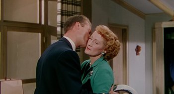 Movie still from “The Caine Mutiny” (1954), directed by Edward Dmytryk – An older woman and a younger man kissing; Close Up shot, Low angle