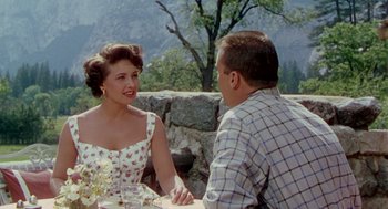 Movie still from “The Caine Mutiny” (1954), directed by Edward Dmytryk – A man and a woman are sitting at a table; Medium shot, Over the shoulder angle