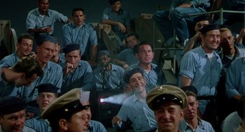 Movie still from “The Caine Mutiny” (1954), directed by Edward Dmytryk – A group of men sitting next to each other in a room; Wide shot, High angle