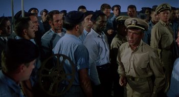 Movie still from “The Caine Mutiny” (1954), directed by Edward Dmytryk – A group of men standing next to each other; Medium shot, High angle