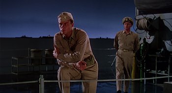 Movie still from “The Caine Mutiny” (1954), directed by Edward Dmytryk – Two men in military uniforms are standing on a deck; Medium shot, Low angle