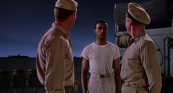 Movie still from “The Caine Mutiny” (1954), directed by Edward Dmytryk – A group of men standing next to each other; Medium shot, Low angle
