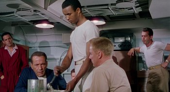 Movie still from “The Caine Mutiny” (1954), directed by Edward Dmytryk – A group of men sitting around a table; Medium shot, Low angle