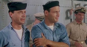 Movie still from “The Caine Mutiny” (1954), directed by Edward Dmytryk – A couple of men wearing hats standing next to each other; Medium shot, High angle