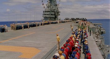 Movie still from “The Caine Mutiny” (1954), directed by Edward Dmytryk – A group of people standing on top of an aircraft carrier; Extreme Wide shot, High angle