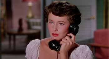 Movie still from “The Caine Mutiny” (1954), directed by Edward Dmytryk – A woman holding a phone up to her ear; Close Up shot, Low angle
