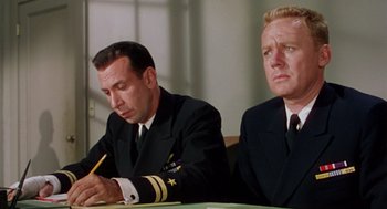 Movie still from “The Caine Mutiny” (1954), directed by Edward Dmytryk – Two men in military uniforms sitting at a table; Medium shot, Low angle