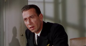Movie still from “The Caine Mutiny” (1954), directed by Edward Dmytryk – A person wearing a suit and tie; Close Up shot, Low angle