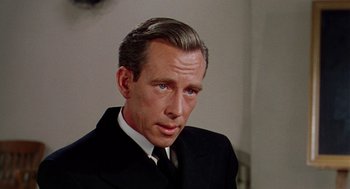 Movie still from “The Caine Mutiny” (1954), directed by Edward Dmytryk – A person wearing a suit and tie; Close Up shot, Over the shoulder angle
