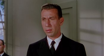 Movie still from “The Caine Mutiny” (1954), directed by Edward Dmytryk – A person wearing a suit and tie; Close Up shot, Low angle