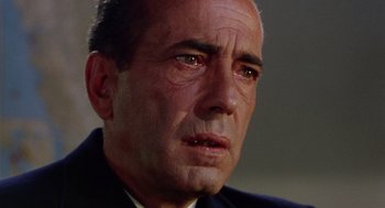 Movie still from “The Caine Mutiny” (1954), directed by Edward Dmytryk – An older man looking sad while wearing a suit; Extreme Close Up shot, Low angle