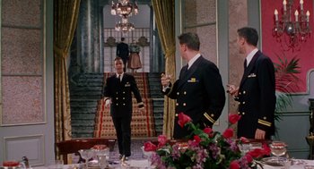 Movie still from “The Caine Mutiny” (1954), directed by Edward Dmytryk – A group of men in military uniforms standing in front of a dining room table; Wide shot, Low angle