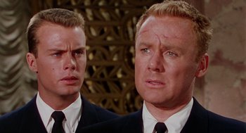 Movie still from “The Caine Mutiny” (1954), directed by Edward Dmytryk – Two men wearing suits and ties looking at each other; Close Up shot, Low angle